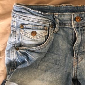 Blue denim shorts with fold at the edge